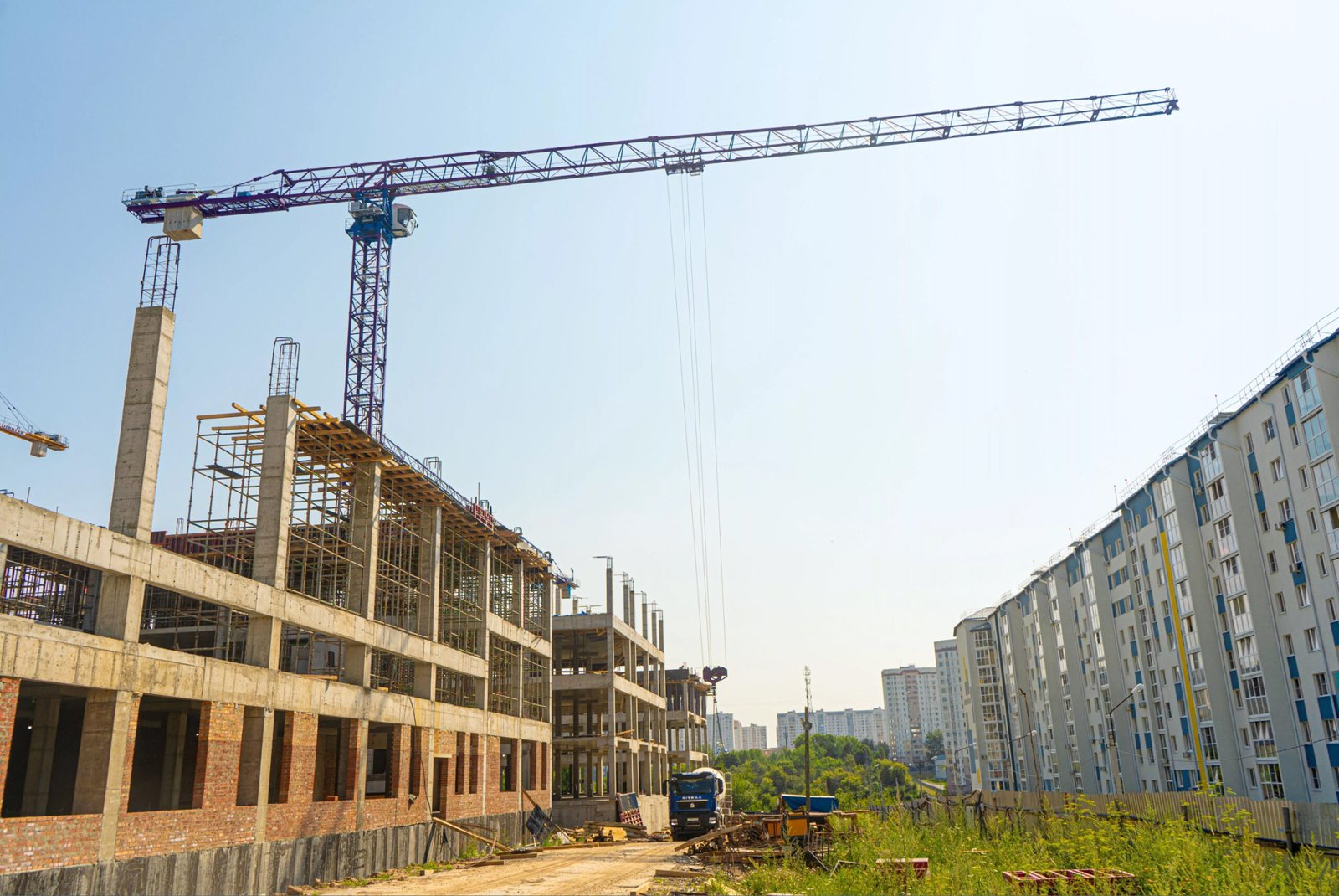 Tower crane at a construction site, showcasing residential building projects