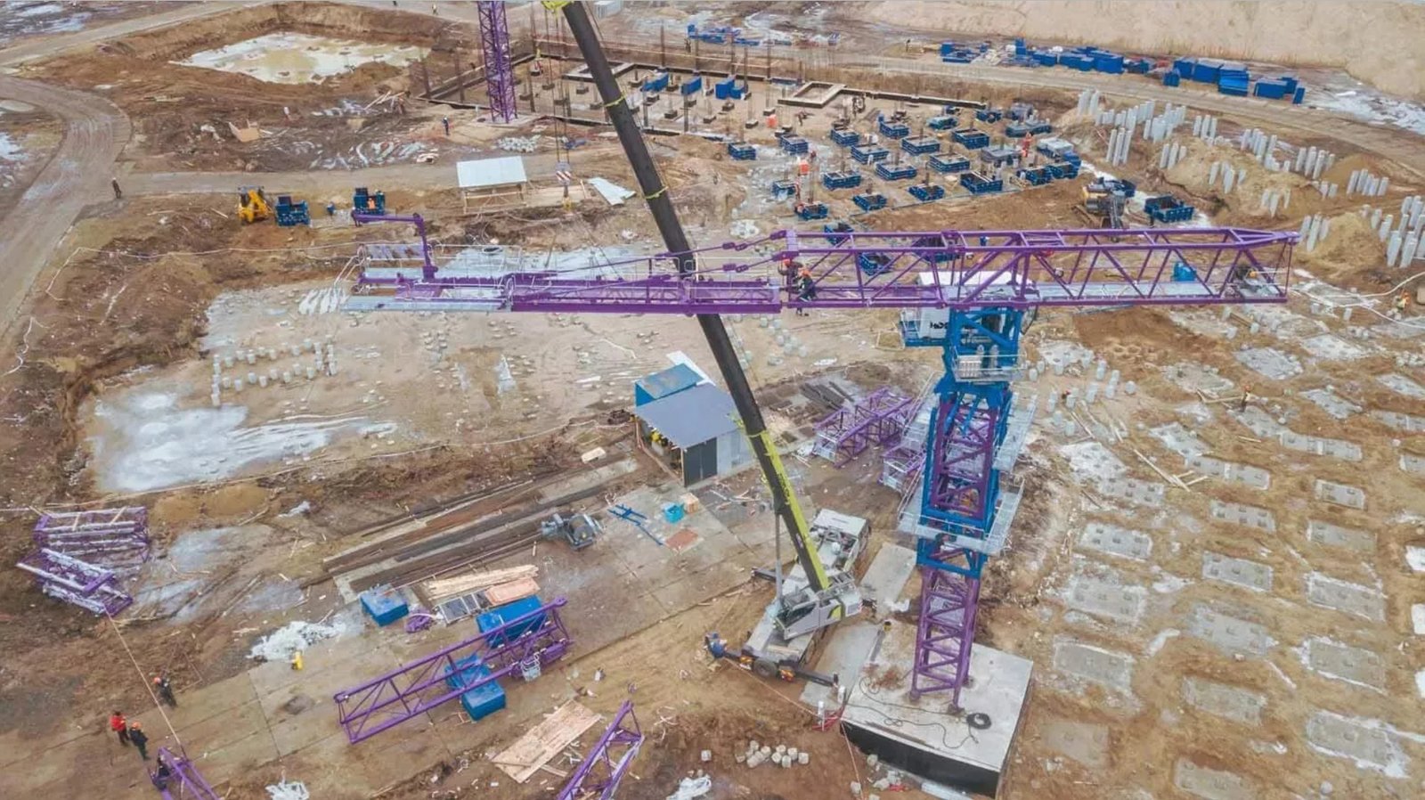 Tower crane assembly process at a large construction site