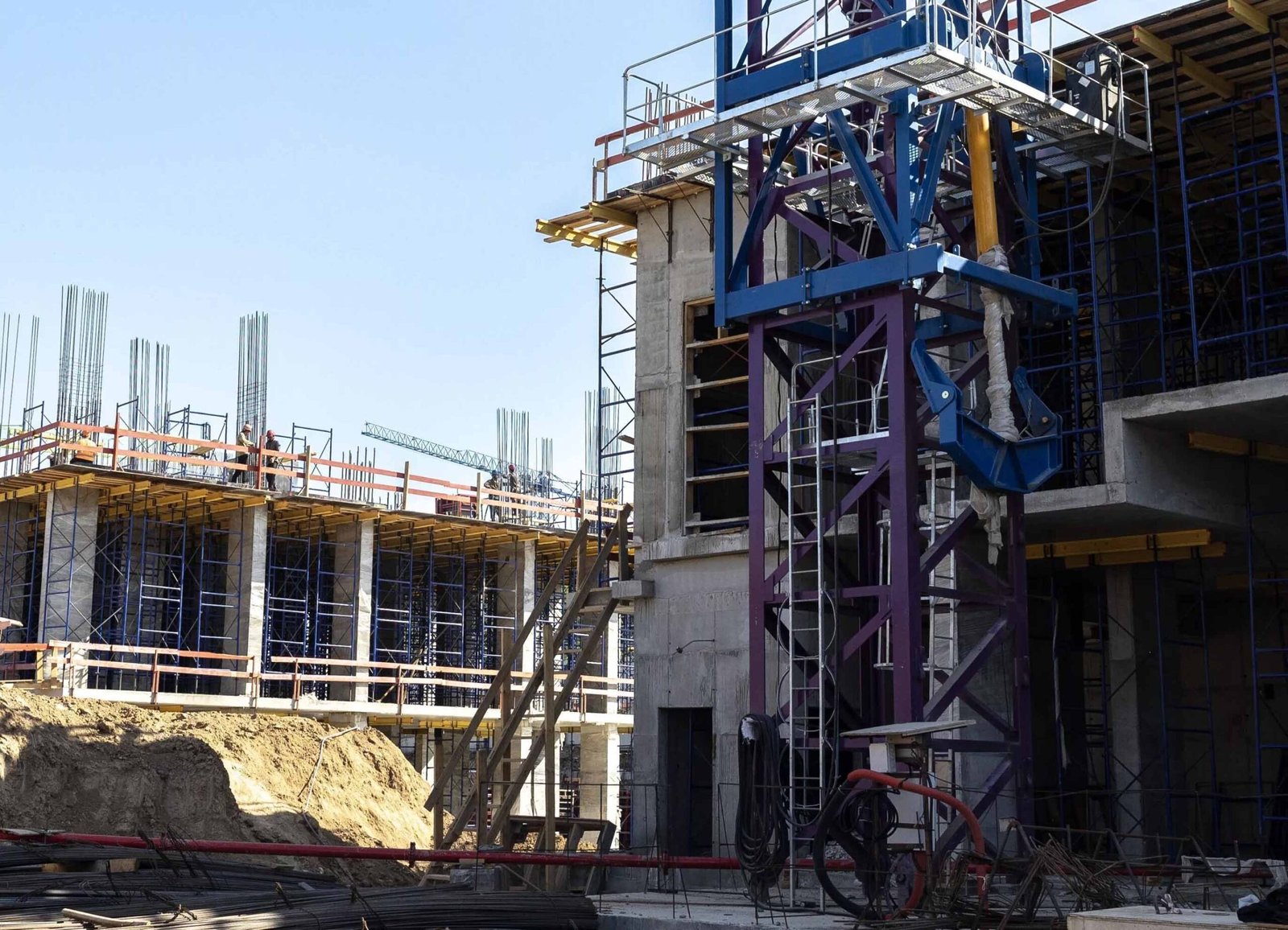 Tower crane base installed at a construction site with reinforced concrete framework.